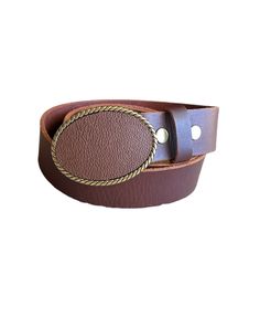 A classic brown leather belt buckle that will make any outfit stylish. The genuine leather buckle is designed on an antique brass finished oval buckle. Pair it with an interchangeable snap belt to style your outfit. The buckle can snap easily on and off to change the look of any outfit.  The belt is not included and may be purchased for an additional cost.  The buckle fits belts up to 1 1/2 inches or 38 mm wide.  The buckles are packaged in an organza bag which is great for gift giving or storing. Luxury Leather Belt Buckles With Belt Clip, Luxury Belt Buckles With Removable Belt For Business, Luxury Belts With Brass Buckle, Luxury Leather Belt With Removable Buckle, Luxury Brown Leather Belt Buckles, Luxury Women's Belts With Brass Buckle, Luxury Brown Belt With Rectangular Buckle, Luxury Business Belts With Brass Buckle, Luxury Cognac Belt Buckles