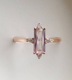 Baguette engagement ring. 1.25ct rectangular emerald cut Peach Elegant Morganite Rings With Baguette Cut, Elegant Rose Cut Square Diamonds Jewelry, Exquisite Rectangular Wedding Rings, Pink Baguette Diamond Rings For Wedding, Pink Baguette Diamond Wedding Rings, Elegant Emerald-cut Morganite Jewelry, Elegant Emerald Cut Morganite Jewelry, Pink Baguette Diamond Wedding Jewelry, Elegant 14k Rose Gold Jewelry With Emerald Cut