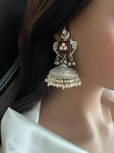 Bollywood Big Jhumka Earrings studded with carved stone, kundan, ghughroo bells and cluster pearls.  Very well made Jhumkis. Style this Jhumka Earrings with any Ethnic Attire and gather lot compliments. Navratri earrings. silver jhumkas. long silver Jhumka earrings.  💕This earring is sure a head turner & a conversation starter.  ✅Shop our collection here: https://www.etsy.com/shop/KKsCulture  WHAT GOES IN  👉🏻Brass base earrings 92.5 silver coating, Kundan, Cluster Pearls, Ghunghroo with carved stone.  👉🏻Push Back Closure.  CARE TIP  1. Keep away from moisture and perfume 2. Store in cotton or zip lock bags or air tight boxes. 3. Spot cleaning only. 4. Jewellery is the last thing you should wear and the first thing you should remove. 👉🏻Send us an email if you need help! KKsCulture [a Oxidized Silver Earrings Jhumka, Navratri Earrings, Big Jhumka Earrings, Oxidized Jhumkas, Silver Jhumka Earrings, Kundan Jhumka Earrings, Vintage Indian Jewelry, Silver Jhumkas, Pretty Jewelry Necklaces