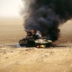 an army tank is on fire in the desert