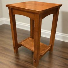 a small wooden table sitting on top of a hard wood floor