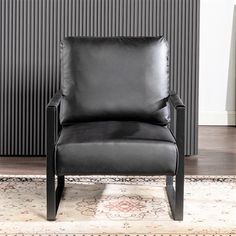 a black leather chair sitting on top of a rug