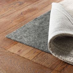 a close up of a rug on the floor with a wooden floor in the background