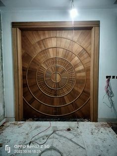 a large wooden door in the middle of a room with wires hanging from it's sides