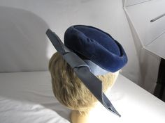 the hat has combs on each side to hold hat in place. Formal Blue Winter Hat, Blue Formal Winter Hat, Vintage Blue Hat For Formal Occasions, Vintage Blue Formal Hat, Vintage Fitted Blue Hats, Blue Fitted Vintage Mini Hats, Cloche Hats, Hat With Bow, Displaying Crystals