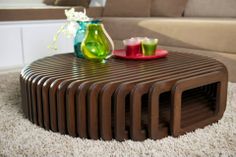 a coffee table with two vases sitting on top of it