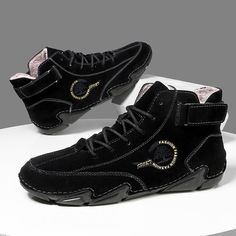 a pair of black sneakers with gold accents