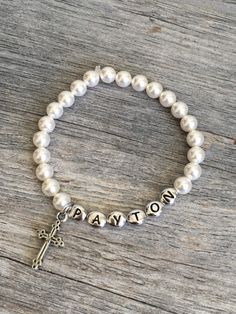 "Personalized first communion pearl bracelet, confirmation gift, jewelry, first communion gift, first communion bracelet, pearl bracelet A beautiful 6mm Swarovksi Crystal Pearl bracelet made just for that special someone! Please let me know the name you want on the bracelet when you checkout. Also, if you could select the child's age this will help me size it correctly. I use stretch magic so the bracelet can easily slip on and off. Bracelet pictured was made with Cream pearls and TierraCast Ant First Communion Pearl Drop Jewelry, Pearl Charm Jewelry For First Communion, Pearl Charm Bracelet For First Communion, Pearl Bracelet For First Communion, Adjustable Pearl Bracelet For First Communion, White Pearl Charm Bracelet For First Communion, White Pearl Charm Jewelry For First Communion, White Pearl Bracelet For First Communion, Pearl White Bracelet For First Communion