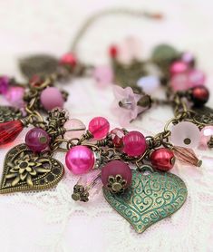 "- Vintage Style Valentines Charm Bracelet Bronze Chain is adjustable from 6.5\" - 8\" with an extension chain The bracelet links are filled with crystals, glass beads and pearls in shades of pink and red Mixed between the beads are vintage style heart charms - all are bronze, some have patina Search my store categories \"Necklaces\" and \"Earrings\" for matching pieces. This is a great gift for Mother's Day Your bracelet will be carefully gift packaged and shipped via USPS First Class Mail. Fee Metal Heart-shaped Beaded Bracelets For Valentine's Day, Heart-shaped Metal Beaded Bracelets For Valentine's Day, Metal Heart-shaped Beaded Bracelet For Valentine's Day, Pink Beaded Charms Bracelets For Valentine's Day, Pink Beaded Bracelets With Charms For Valentine's Day, Valentine's Day Pink Beaded Bracelets With Charms, Pink Metal Beaded Bracelets With Charms, Pink Metal Beaded Bracelet With Charms, Heart-shaped Charms Beaded Bracelets For Jewelry Making