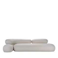 a white couch sitting on top of a white floor