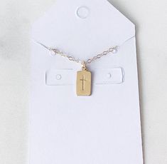 Tiny Gold Filled Small Bar Necklace This is such a sweet and dainty gold filled cross rectangle bar necklace. This necklace looks great by itself or paired with other necklaces for a layered look. This small pendant hangs on a gold filled cable chain. Please choose the length of chain you desire at the drop down menu. I find this chain glistens in the sunlight... so pretty. 🌞🌞 All components are gold filled. Dainty Rectangular Bar Necklace As Gift, Dainty Gold Rectangular Charm Necklace, Simple Gold Cross Necklace As A Gift, Gold Minimalist Personalized Cross Necklace, Gold Personalized Minimalist Cross Necklace, Dainty Gold Bar Necklace With Rectangular Pendant, Rectangular Pendant Bar Necklace With Adjustable Chain As Gift, Minimalist Crucifix Charm Necklace As Gift, Minimalist Personalized Gold Cross Necklace