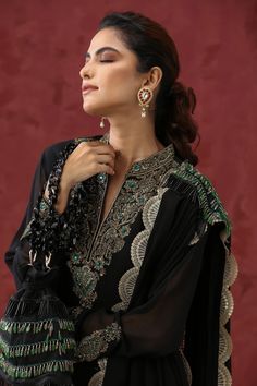 Black kurta with floral embroidery detailing. Comes with sharara, embroidered dupatta and potli bag.
Component: 4
Pattern: Embroidery
Type Of Work: Zardozi, Stones, Beads
Neckline: Mandarin
Sleeve Type: Sheer
Fabric: Georgette and Organza
Color: Black
Other Details: 
Stole style dupatta
Lace borders
Occasion: Sangeet - Aza Fashions Embroidery Zardozi, Dupatta Lace, Collar Kurta, Black Kurta, Kurta Sharara Set, Organza Embroidery, Kurta Sharara, Potli Bag, Embroidery Detailing