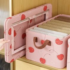 a child's closet with pink and red storage bins