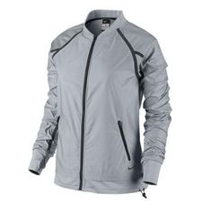 a women's nike jacket with zippers on the front and side, in grey