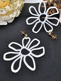 The whimsical design of these white flower earrings is sure to be beloved by many. Every time you wear these light dangle for women, you'll be reminded of those special moments that bring joy and beauty into our lives. Lightweight and delicate, these earrings make an excellent gift for yourself or someone special. Whether you're attending a cocktail party or a casual day out, these earrings will enhance any look and will turn heads. ☆ Other colors are available upon request. ☆ Each pair of earrings comes with an extra set of earring backs. ☆ Earring's Size: 1.5 inch wide, 2 inches long.   ☆ Materials: Resin epoxy, silver post stud with butterfly back. ☆ PLEASE NOTE: These products ARE  handmade. Therefore, there might be a slight variation in size, color, etc, when duplicating. ☆ Shipping White Flower Earrings, White Flower Earring, Earring For Women, Whimsical Design, Special Moments, White Flower, Earring Backs, Flower Earrings, Jewelry Earrings Studs