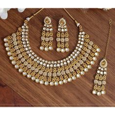 Treat yourself to our lovely Gold Nyra Jewelry Set, handcrafted with pearls, and high-quality kundan on gold plating. Perfect for weddings and festivities, this kundan jewelry set can be paired with your favorite sari or lehenga. Specifications Materials used: kundan, beads, pearls, gold plating At Romikas, we pride ourselves on the craftsmanship and high quality of our jewelry, designed to enhance your natural beauty. Please contact us with any questions. Gold Gota Work Wedding Sets, Gold Gota Work Sets For Wedding, Gold Kundan Chandbali Necklace With Stone Work, Kundan Bridal Sets With Chandbali Shape For Celebration, Kundan Chandbali Bridal Sets For Celebration, Chandbali Kundan Bridal Sets For Celebration, Wedding Temple Jewelry Sets With Gota Work, Kundan Pearl Necklace For Wedding, Kundan Temple Jewelry Necklace For Wedding