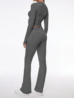 Step out in style with our contemporary two-piece set, combining comfort and fashion in one. The ensemble features a body-hugging crop top with long sleeves and matching low-rise pants with a gentle flare. Each piece is crafted from high-quality modal fabric that's both soft to the touch and elastic for durability. Features: Quality Fabric: The set is made from premium modal, known for its softness and elasticity, ensuring both comfort and longevity. Chic Design: With a round neckline and croppe Fitted Two-piece Pant Set With Long Sleeves, Fitted Two-piece Set With Long Sleeves, Fitted Two-piece Long Sleeve Pant Set, Fitted Wide Leg Solid Color Sets, Fitted Solid Color Wide Leg Sets, Solid Color Fitted Wide Leg Sets, Fitted Long Sleeve Pant Set For Spring, Solid Fitted Long Sleeve Sets, Solid Color Fitted Long Sleeve Sets