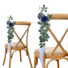 two wooden chairs with flowers and greenery on the back one chair has a seat cushion