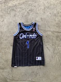 Vintage Orlando Magic Reversible Jersey Penny Hardaway Size M in great vintage condition. Size: M Material: Polyester measurement: - Chest(armpit to armpit: 52cm(20.4") - Length from the backside(Center bottom of the collar to center bottom of the garment): 67cm(26.3") - Shoulder to shoulder seam: 39cm(15.3") NOTE: Because of the age, clothing can shrink or the sizing from that time wasn't the same as the size from modern clothing. Make sure you have checked our measurements first before purchas Collegiate Sleeveless Jersey For Streetwear, Casual Sleeveless College Jersey, Collegiate Black Sleeveless Top, Sleeveless Jersey For Game Day, Sleeveless Cotton Jersey For Sports Season, Sleeveless Cotton Jersey For Sports, Sleeveless Cotton Jersey For Streetwear, Cotton Sleeveless Jersey For Streetwear, Collegiate Sleeveless Jersey Top