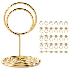 a set of gold rings on a stand with several circles in the middle and one ring at the bottom