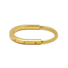 Tiffany & Co.  Lock Bangle in Yellow Gold with Diamond Accents Wrist Aficionado Everyday Yellow Gold Open Ring Bracelets, Stackable Open Ring Bracelets For Everyday, Everyday Yellow Gold Open Ring Bracelet, Modern Hoop Bangle For Everyday, Modern Hoop Bangle For Everyday Wear, Modern Adjustable Oval Bangle, Polished Bangle Bracelet For Promise Occasion, Modern Gold Open Ring Bracelet, Modern Adjustable Hoop Bracelets