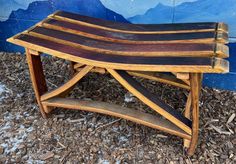 a wooden bench sitting in front of a blue wall