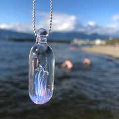 "Jewel like tidal anemone necklace in borosilicate glass and sterling silver is a stunning reflection of the mystery of the ocean. Pendant is approximately 1.5\" L x 0.4\" W  Pendant sold separately or can include a sterling silver 925 stamped 1mm 18\", 24\" or 30\" chain.  Select your chain length when checking out.  Each piece is completely handmade and is one of a kind. Therefore, sizes are approximate and design is unique. Thanks for supporting small! Hand made in Vancouver, BC, Canada" Handmade Clear Keepsake Jewelry, Handmade Clear Drop Jewelry, Iridescent Minimalist Jewelry Gift, Minimalist Iridescent Jewelry As Gift, Minimalist Iridescent Jewelry For Gifts, Iridescent Minimalist Jewelry For Gift, Clear Glass Drop Jewelry, Clear Drop-shaped Glass Jewelry, Clear Glass Jewelry For Healing