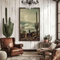 a living room filled with furniture and a painting hanging on the wall next to a chair