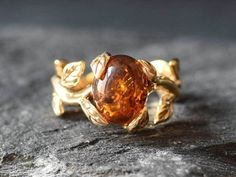 Gold Amber Ring set with a Natural Amber in a top grade & natural amber color, at 10x8mm, 3 Carats, from Europe. Band Width 1.9mm. Leaf Ring made of Gold Vermeil: 18k Gold over Solid 925 Sterling Silver ☞ made to last. Matching Earrings: www.etsy.com/listing/1677535791 Matching Pendant: www.etsy.com/uk/listing/1165178492 D E T A I L S ✓ Adina Stone GIFT BOX provided ♕ GUARANTEE on materials ♕ Hallmark on each piece ✓ Stone: Natural Amber, 10x8mm, 3 Carats (Europe) ✓ Band Width 1.9mm, Thickness 1 Leaf Ring Design, Amber Engagement Ring, Proposal Ring Gold, Gold Leaf Ring, Green Diamond Rings, Silver Leaf Ring, Brownish Yellow, Earrings Matching, Gold Leaf Rings