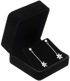 an open black velvet jewelry box with two white flowers on the front and one flower on the back