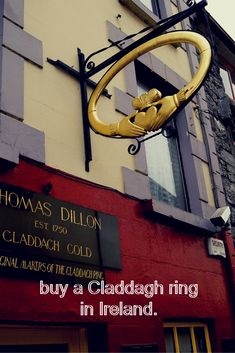 the sign on the building says thomas dilllon, claddagh gold and has a golden monkey hanging from it's side