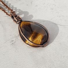 Tigers Eye is a Beautiful Quartz gemstone sourced from the ground and is 100% natural. Are you looking for a beautiful natural gemstone Necklace?  Do you want endless compliments everywhere you go? Maybe you want more motivation and inner strength in your life? If so... You might have just found what you've been looking for... 🤩  This handcrafted natural Tigers Eye necklace could be your next favorite!  A teardrop pendant that is used to bring more self-confidence and inner strength. known for Wire Wrapped Teardrop Pendant Necklace For Healing, Brown Teardrop Gemstone Jewelry, Spiritual Hand Wrapped Teardrop Pendant Necklace, Artisan Hand Wrapped Teardrop Necklaces, Wire Wrapped Teardrop Pendant Necklace Gift, Teardrop Gemstone Crystal Necklace For Meditation, Teardrop Wire Wrapped Drop Necklace Gift, Teardrop Pendant Drop Necklace Gift, Handmade Spiritual Teardrop Drop Necklace