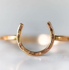 Lucky Horseshoe Ring - Small - Equestrian Ring This "Lucky Horseshoe" ring is made using 18 gauge wire that is hand formed and hammered, and measures approx 9mm across. The band is 16 gauge hammered wire that fits comfortable alone or stacking. This ring is a part of "The Ranch Collection": A classic, American collection inspired by the western culture of cowboys, horses, and the spirit of the great Wild West. Each will vary slightly as they are individually made by hand. When kept as a talisman Jewelry Western, Horseshoe Ring, Sweet Jewelry, Western Culture, Gem Show, Lucky Horseshoe, Classic American, The Ranch, Recycled Sterling Silver