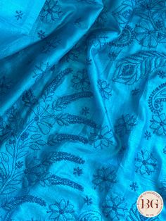 This exquisite blue silk piece showcases intricate Chikankari embroidery, a handcrafted technique that dates back to the Mughal era. Designed to elevate any outfit, this one-of-a-kind piece exudes timeless elegance and luxury. Experience the art of Chikankari and indulge in the finest craftsmanship with this stunning silk creation. Chikankari on Silk - Blue Saree comes with a blouse piece. Fall and pico done. Fully stitched blouse shown in pictures is optional and can be purchased seperately from our blouses and croptops section. For saree video please connect with us on whatsapp @469-937-0606 Ready to be shipped in USA from San Diego, California. All pictures are original pictures. Colors may slightly vary due to pic resolution. Transitional Blue Art Silk Blouse Piece, Transitional Blue Chanderi Blouse Piece, Blue Embroidered Silk Blouse Piece, Blue Festive Blouse Piece For Transitional Season, Blue Blouse Piece For Wedding In Transitional Season, Traditional Slub Silk Fabric With Floral Embroidery, Blue Semi-stitched Art Silk Blouse Piece, Semi-stitched Art Silk Blouse Piece In Blue, Unstitched Blue Blouse Piece For Festive Occasions