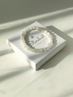 ✰ This tender white moonstone bracelet is a treasure. It has a very pure feminine energy and provides calmness to its wearer. Lovely gift that comes in a premium gift box by Stardust! The bracelet ahs beautiful blue sparkles and features one clear crystal bead to amplify the energy flow! Wearings moonstone jewelry: ♥ Boosts inner growth and strength. ♥ Brings feminine energy n higher level. ♥ Attracts abundance in life. ♥ Soothes emotional instability and stress, and stabilises the emotions, pro White Moonstone Bracelets For Everyday, White Moonstone Bracelet For Everyday, White Moonstone Beaded Bracelet With 8mm Beads, White Minimalist Crystal Bracelet As A Gift, White Minimalist Crystal Bracelet For Everyday, Elegant Moonstone Beaded Bracelets As Gift, Elegant Moonstone Crystal Bracelet For Gift, Minimalist White Crystal Bracelet For Everyday, Elegant Moonstone Beaded Bracelet As Gift