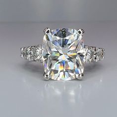 a cushion cut diamond ring with three side stones