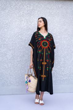 "This beautiful Kaftan with the Siwa inspired embroidery is a bohemian and flashy dress that will catch everyone's eyes. This Kaftan is ideal to wear for any casual occasion. Whether taking a trip down the shopping lane, or home-based kitty parties, or about anything else, wearing this dress will make you feel classy and comfortable. Fabric : 70% Egyptian Cotton; 30% Polyester. Size : Free sized dress. This Kaftan is a free sized dress meaning that it comes in one size only that fits any size fr Black Floral Embroidered Beach Dress, Black Floral Embroidered Dress For Beach, Beach Black Embroidered Dress With Floral Details, Black Embroidered Dress With Floral Details For Beach, Black Beach Dress With Floral Embroidery, Black Embroidered Dress For Beach, Black Cotton Free Size Dress, Black Cotton Dress Free Size, Black Free Size Cotton Dress