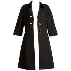 1960s Vintage Black Wool Coat | From a unique collection of rare vintage Coats and Outerwear at https://www.1stdibs.com/fashion/clothing/coats-outerwear/. Modern Outerwear With Hidden Button Closure For Evening, Modern Evening Outerwear With Hidden Button Closure, Modern Tailored Black Wool Coat, Fitted Black Wool Coat For Evening, Evening Wool Outerwear With Buttons, Wool Evening Outerwear With Buttons, Chic Black Blazer With Covered Buttons, Black Evening Outerwear With Hidden Button Closure, Elegant Evening Outerwear With 3/4 Sleeves