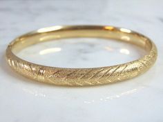 "FOR SALE IS THIS WONDERFUL WOMENS 14k GOLD BRACELET THAT WEIGHS 13.5g AND MEASURES ABOUT 1/4\" WIDE WITH AN OPENING THAT IS 2 5/8\" BY 2 3/8\". PIECE IS UNMARKED BUT HAS BEEN TESTED. ANY OTHER QUESTIONS PLEASE ASK. BE SURE TO CHECK OUT SOME OF MY OTHER GREAT ITEMS UP FOR SALE. THANK YOU. IF THERE ARE ANY ISSUES PLEASE CONTACT US, WE'RE ALWAYS HAPPY TO TRY TO HELP YOU OUT AS BEST AS WE CAN." Gold Oval Bracelet Stamped 14k, Gold Bangle Stamped 14k As Gift, Formal Gold Bracelet With Shiny Finish, Formal Shiny Finish Gold Bracelet, Elegant 14k Gold Diamond-cut Bangle, Elegant 14k Gold Bangle With Diamond Cut, Elegant 14k Gold Diamond Cut Bangle, Oval Gold Bracelet Stamped 14k, Luxury 14k Stamped Yellow Gold Bangle