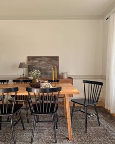 a dining room table with four chairs around it