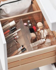 an open drawer filled with cosmetics and other items