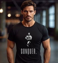 --- Ronnie Coleman Conquer Bodybuilding T-Shirt --- This bodybuilding t-shirt, from our new gym collection, is designed to elevate your workout wardrobe to the next level. Crafted from 100% cotton, this shirt offers unmatched comfort and breathability. With both a retro and modern design, it is as stylish as it is functional.   The t-shirt runs true to size - if you pretend a more oversized look, go for one or two upper sizes. Please check the size chart available in the photos. ▶ 100% Cotton (a Black Branded T-shirt For Gym, Black Sporty Muscle Tee With Letter Print, Branded Crew Neck Workout T-shirt, Sporty Gym T-shirt With Branding, Black Branded Gym Tops, Black Branded Tops For Gym, Black Branded Tops For The Gym, Black Sports Muscle Tee With Letter Print, Black Muscle Tee With Letter Print For Sports