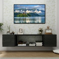 a living room with a large painting on the wall next to a table and bookshelf