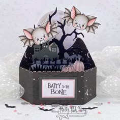 a card with bats and tombstones in the shape of a batty - to - the - bone box