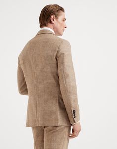 Wool and alpaca Prince of Wales deconstructed blazer with large peak lapels The retro inspiration of this jacket with large peak lapels is paired with the excellence of Brunello Cucinelli fabrics. The ultra-soft, slightly full texture of the wool and alpaca blend enhances the Prince of Wales pattern with a nuanced effect. The “Solomeo Shoulder”, named after the hamlet where the company is located, characterizes the Brunello Cucinelli jacket with distinct proportions. The tapered and pronounced c Luxury Single Breasted Tweed Jacket With Lapel Collar, Luxury Single Breasted Tweed Jacket With Notch Lapel, Bespoke Tailored Fall Blazer, Bespoke Tailored Blazer For Fall, Tailored Fall Blazer With Shawl Collar, Bespoke Single-breasted Outerwear With Lapel Collar, Tailored Shawl Collar Blazer For Fall, Wool Three-piece Suit Single Breasted, Bespoke Notch Lapel Suits For Fall