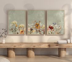 three paintings on the wall above a wooden bench