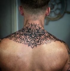 a man with a tattoo on his back