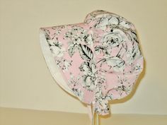 This pretty pink floral baby bonnet will look adorable on an infant, toddler and little girl, and it offers some shade from the sun with its wide brim. There is fabric at the back of the neck for added sun protection. It would be great for special occasions, and it's durable enough for daily wear in spring, summer and fall. Sweet for your own little girl, and a special handmade baby gift. **This sunbonnet fits pretty true to the age of baby if she is of average size** I made this sun hat using h Adjustable Sun Hat For Spring Gift, Brimmed Sun Hat For Spring, Handmade Pink Sun Hat For Spring, Spring Gift Adjustable Sun Hat, Spring Sun Hat With Curved Brim, Spring Sun Hat With Curved Brim As Gift, Spring Gift Sun Hat With Curved Brim, Wide Brim Sun Hat As Spring Gift, Pink Floral Print Hat For Summer