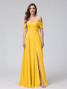 a woman in a yellow dress posing for the camera