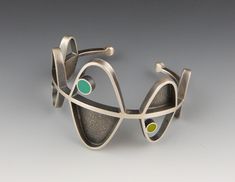 The design for the Helix Cuff bracelet was inspired by the ordered symmetry of DNA strands. Hand fabricated from sterling silver with an oxidized and brushed finish. Inlays of eco-friendly, soy-based resin. The resin is hand-tinted with non-toxic pigments. Fits 6” to 6.5” wrist, other sizes may be custom made. 1.625” x Unusual Bracelets, Norway Design, Silver Smithing, Contemporary Bracelets, Cuff Bracelets Handmade, Metal Cuff Bracelet, Handmade Jewelry Bracelets, Metal Clay Jewelry, Modernist Jewelry